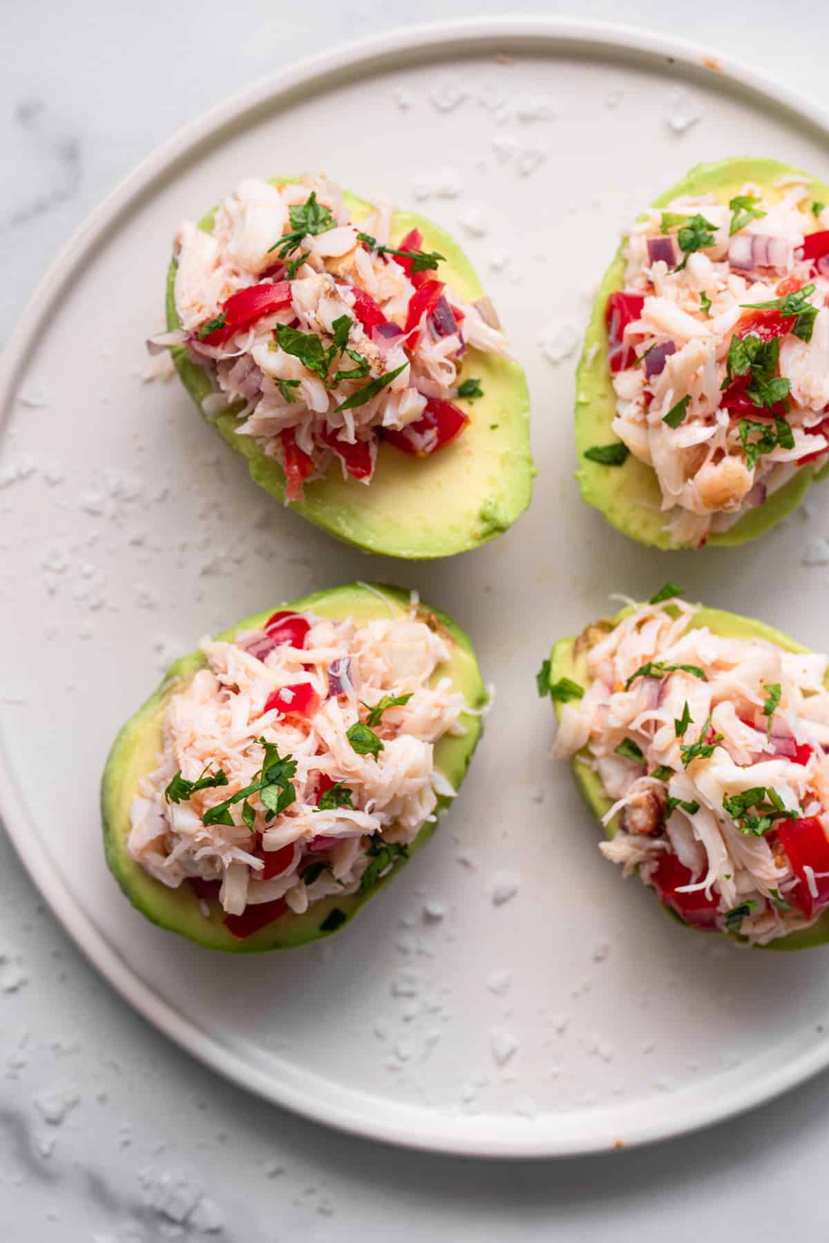 top view of crab avocado salad on a plate with cilantro