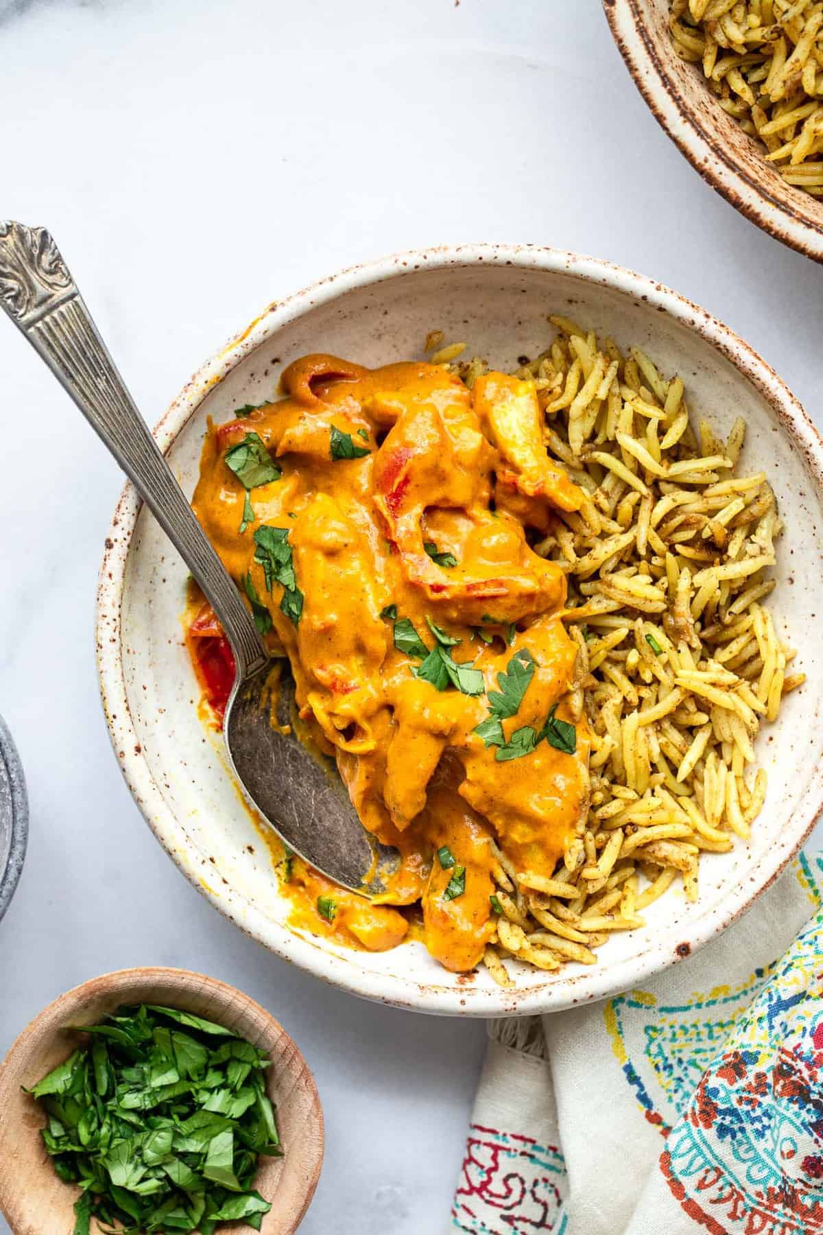 paleo chicken curry in a bowl over turmeric spiced rice