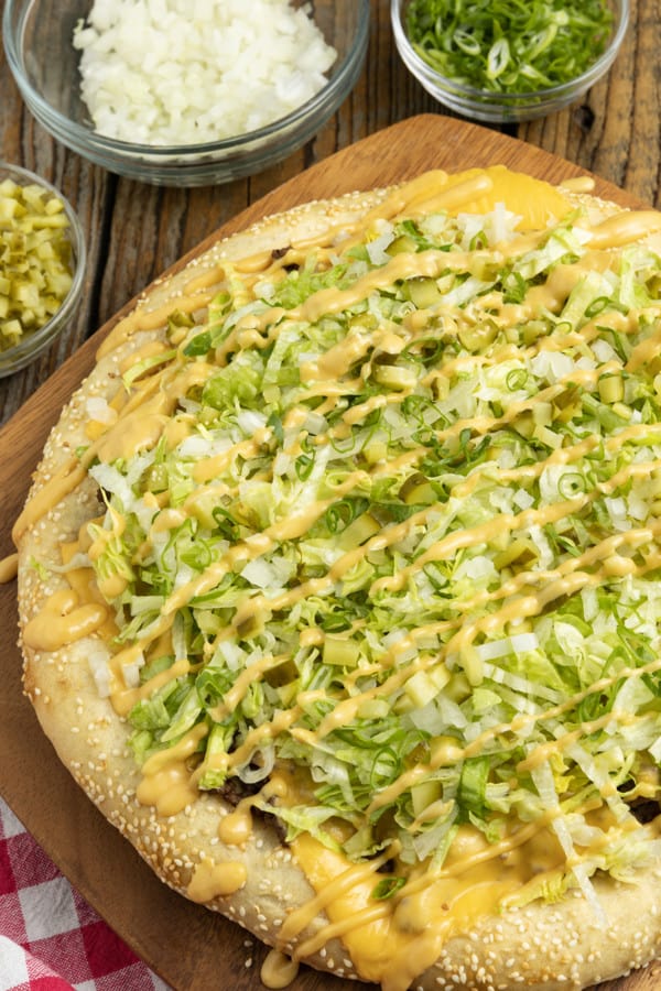 Big Mac Pizza brings the classic “two all beef patties, special sauce, lettuce, cheese, pickles, onions, on a sesame seed bun” taste that you love to pizza in this irresistible recipe! It’s got that craveable fast-food flavour but made fresher than the real thing in your own home for pizza night.