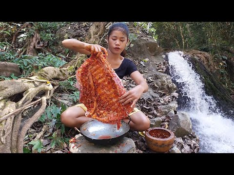 Pork ribs grilled spicy delicious for dinner near waterfall - Survival cooking in jungle