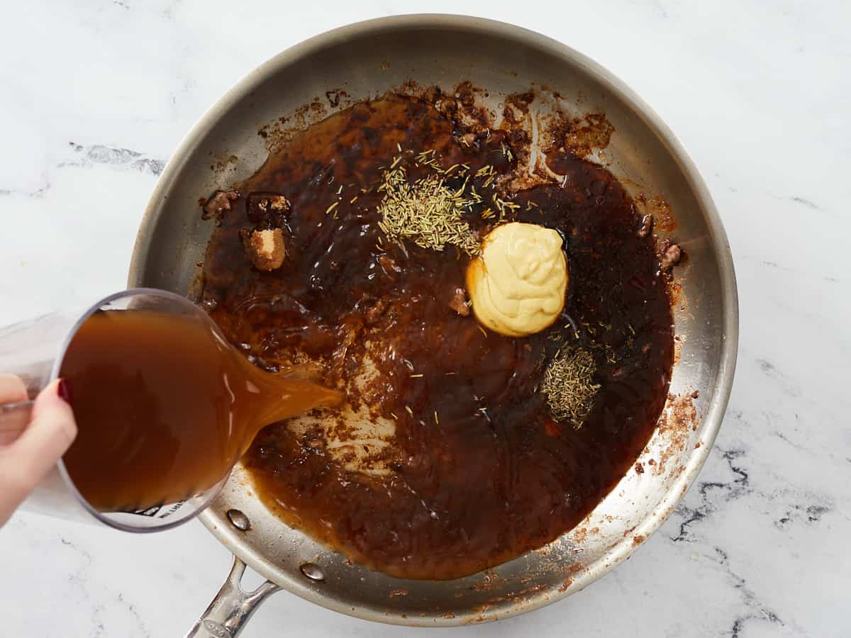 Ingredients for the gravy added to the skillet.