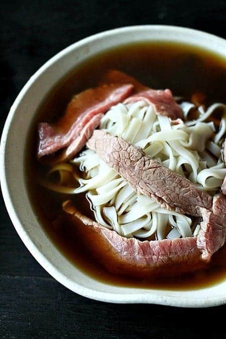 Pho or Vietnamese Beef Noodle Soup waiting for garnish from foodiewithfamily.com