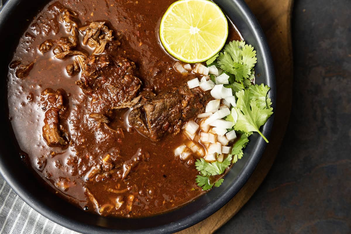 Instant Pot Birria makes fast work of the complex, rich, flavourful Mexican stewed or braised meat that is Birria. While traditional birria is made with goat marinated and then simmered for hours, our version of “birria de res” is done in a fraction of the time and made with more readily available beef.