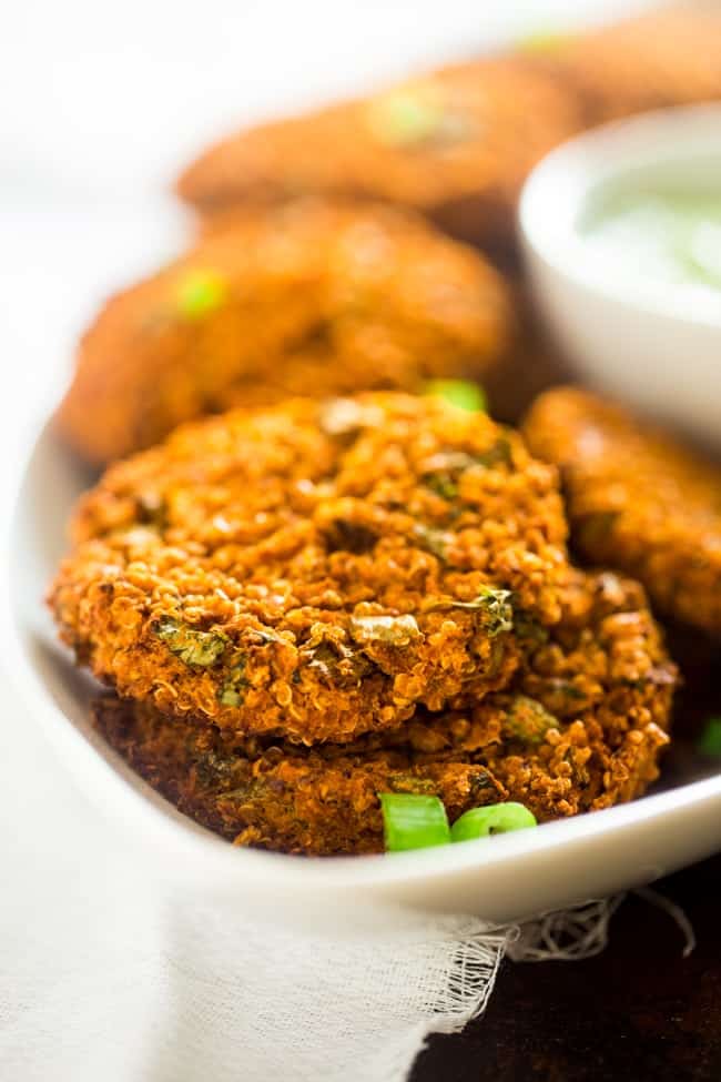 Vegan Buffalo Patties with Avocado Dip - These patties taste just like buffalo chicken, but they're totally meat free and made with cauliflower and quinoa! They're a spicy, crunchy and creamy appetizer for game day! | Foodfaithfitness.com | @FoodFaithFit