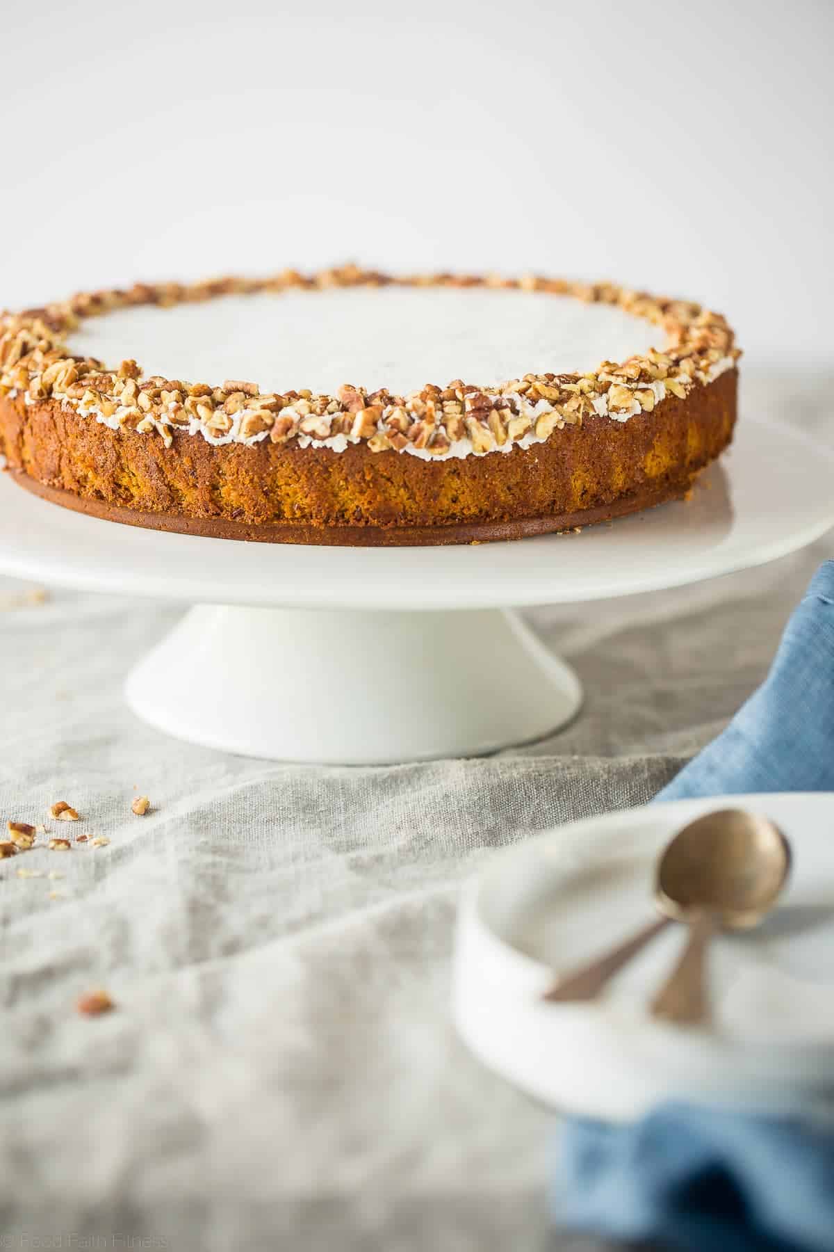 Gluten Free Paleo And Vegan Carrot Cake Cheesecake - This super easy, rich, creamy, paleo and vegan friendly cheesecake tastes like carrot cake but is secretly dairy, gluten, egg and refined sugar free and healthy! Perfect for Easter! | Foodfaithfitness.com | @FoodFaithFit