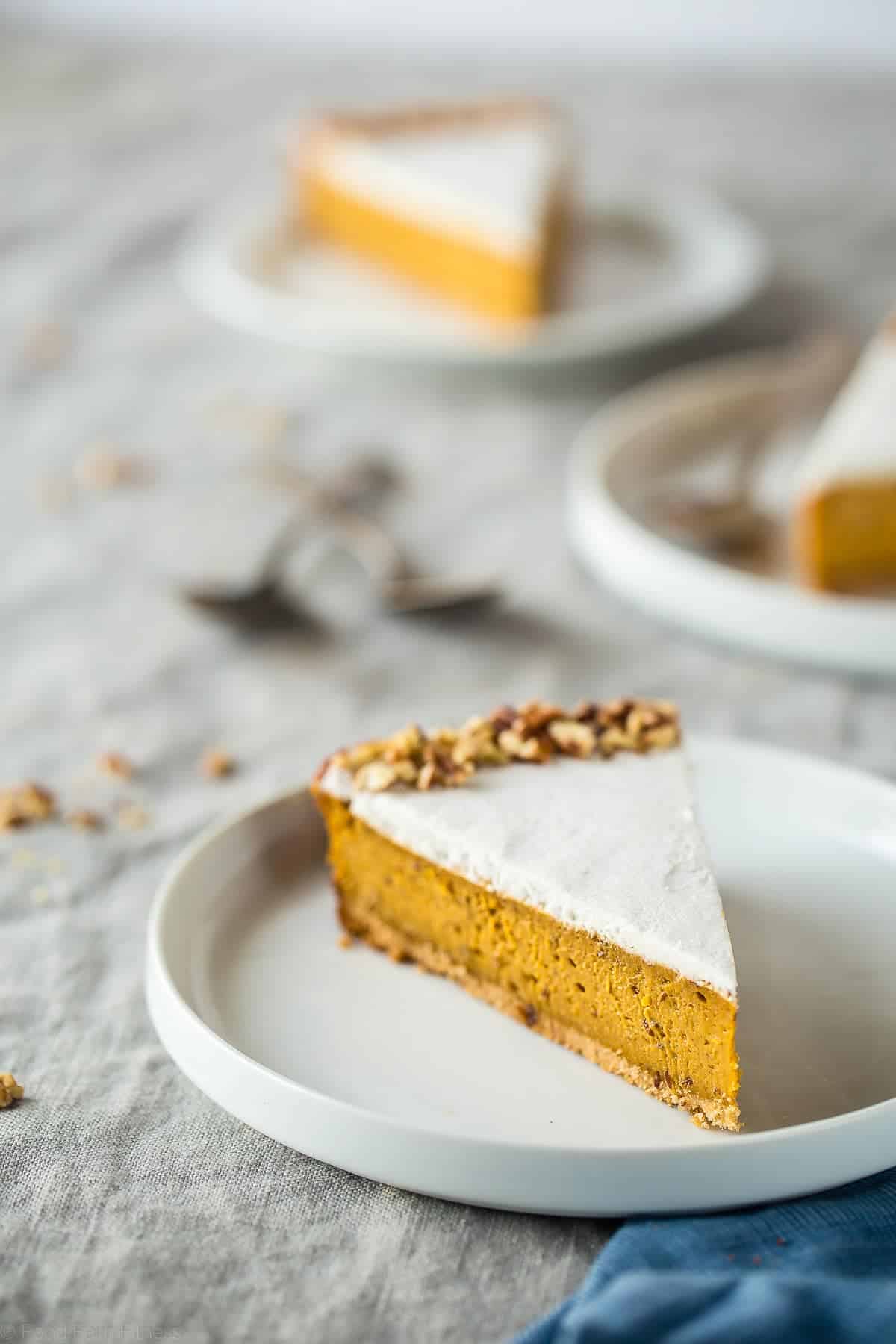 Gluten Free Paleo And Vegan Carrot Cake Cheesecake - This super easy, rich, creamy, paleo and vegan friendly cheesecake tastes like carrot cake but is secretly dairy, gluten, egg and refined sugar free and healthy! Perfect for Easter! | Foodfaithfitness.com | @FoodFaithFit