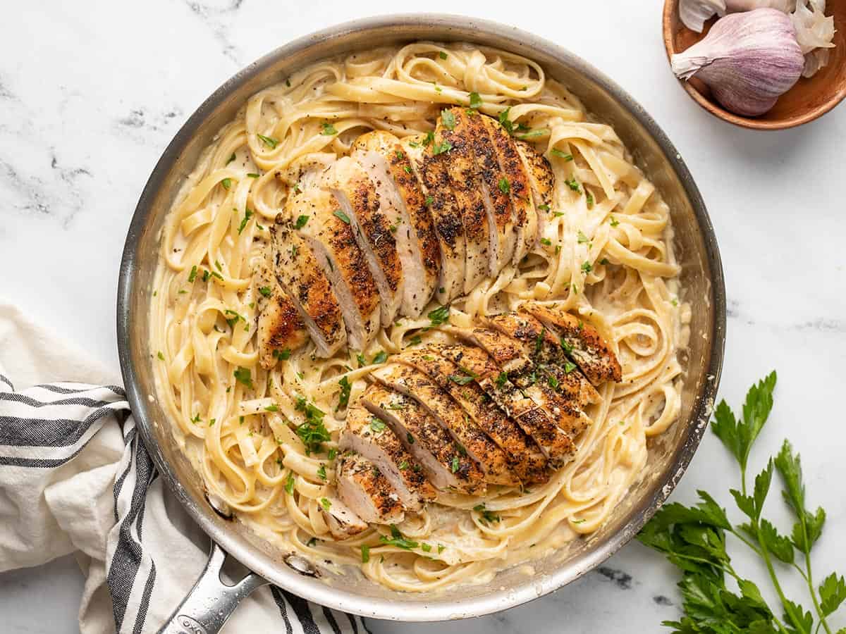 Overhead view of chicken alfredo in the skillet.