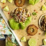 Make taco nights magical with jerk chicken tacos! Fresh lettuce leaves stacked on charred tortillas are piled high with juicy jerk chicken, grilled pineapple slices, diced bell peppers, thinly sliced onions, a drizzle of sauce or spoonful of mango salsa.