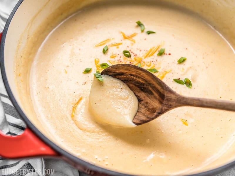 Cheesy Cauliflower and Potato Soup is rich and creamy without being overly heavy. Eat your vegetables and enjoy them, too! Budgetbytes.com