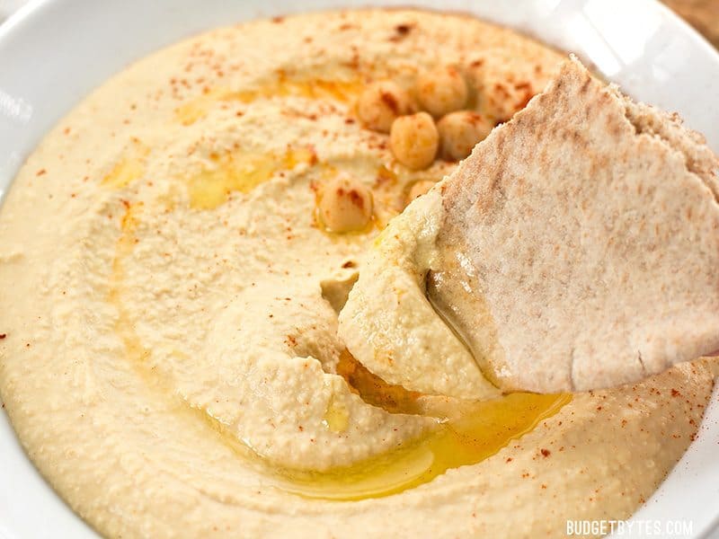 Homemade hummus is quick, easy, and inexpensive, and can be made with several different flavor add-ins. Here are four delicious flavors to try. BudgetBytes.com