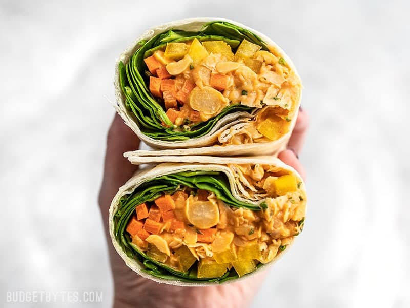 A Sriracha Chickpea Salad Wrap cut open, with open sides facing viewer.