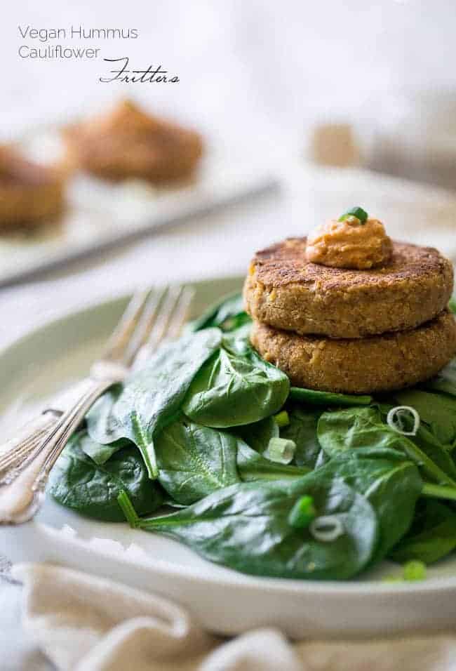 6 Ingredient Vegan Cauliflower Fritters With Hummus - Chickpeas and cauliflower are blended together, pan fried and topped with hummus so they're crispy on the outside and creamy on the inside. A quick, easy and healthy meatless Monday meal for under 350 calories! | Foodfaithfitness.com | @FoodFaithFit