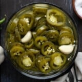 Overhead view of a bowl full of pickled jalapenos.