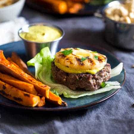 Paleo Burgers with Grilled Pineapple and Curry Cashew Cream - Topped with smooth and spicy curry cashew cream, grilled pineapple and wrapped with lettuce, this burger is a low carb, healthy meal for under 250 calories! | Foodfaithfitness.com | @FoodFaithFit