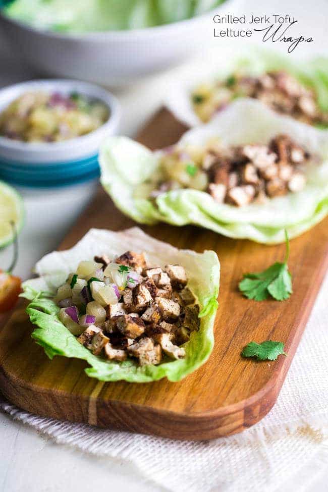 Vegetarian Lettuce Wraps with Jerk Grilled Tofu - These lettuce wraps are piled with spicy-sweet and crispy grilled tofu and pineapple salsa. They're a quick and easy, healthy meal for Summer grilling or Meatless Monday! | Foodfaithfitness.com | @FoodFaithFit