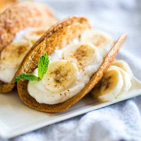 Greek Yogurt Banana Pancake Tacos - These gluten free banana pancakes are filled with Greek yogurt and rolled up like tacos! They're a fun, healthy breakfast for only 100 calories per taco! | Foodfaithfitness.com | @FoodFaithFit