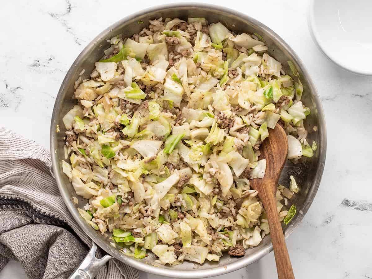 Overhead view of the finished sautéed beef, cabbage, and rice in the skillet.