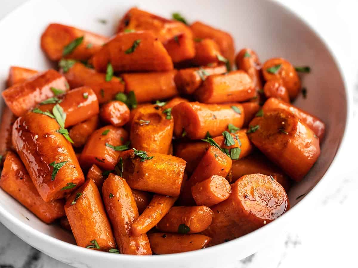 close up side view of a bowl of honey balsamic glazed carrots