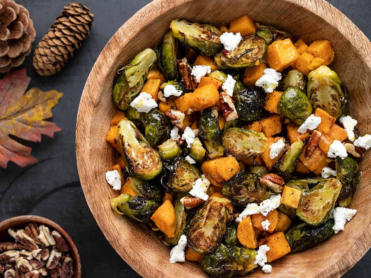 Close up view of roasted Brussels Sprouts Salad in a wooden bowl.