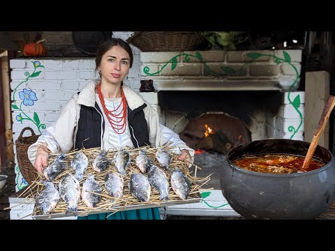 Village Cooking. Woman is cooking authentic BORSCHT with dried fish and buckwheat donuts