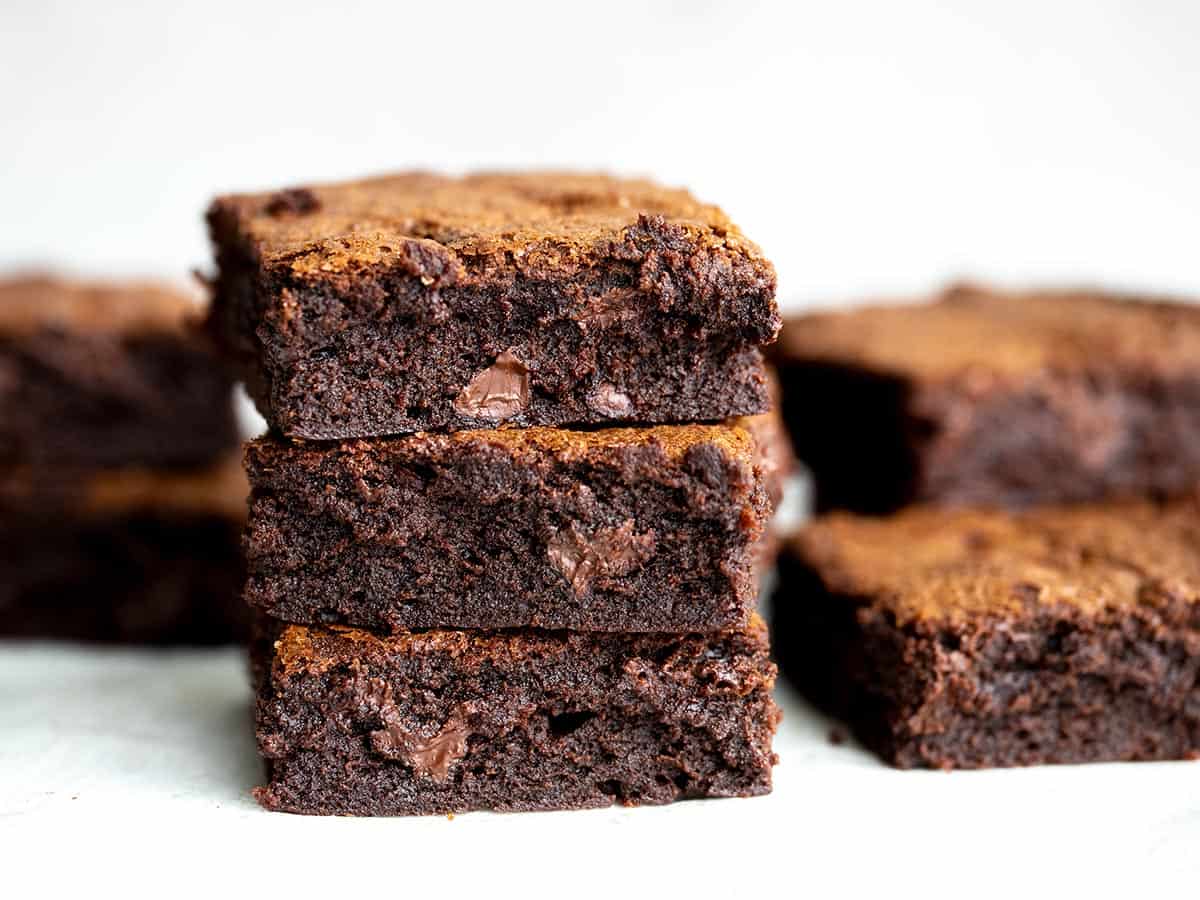 Side view of a stack of fudgy homemade brownies.