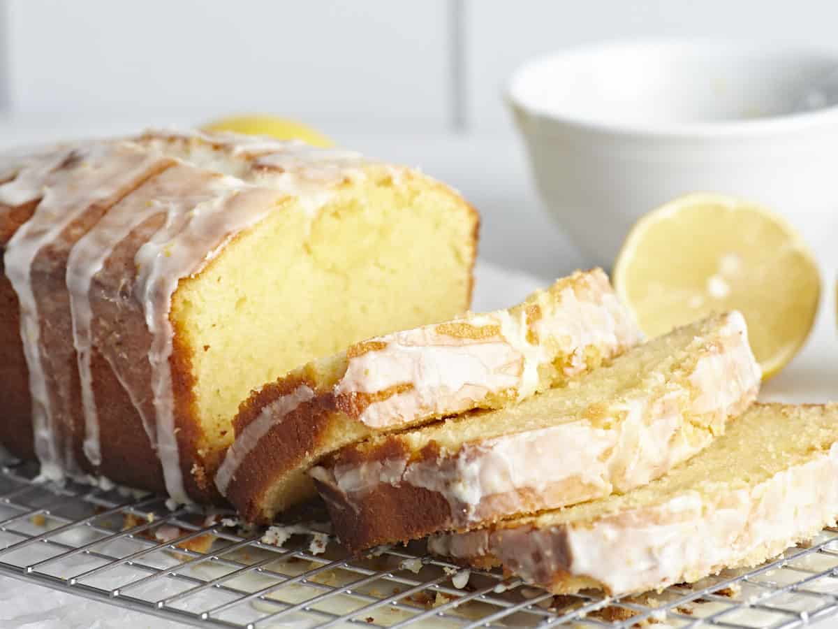 Side view of a sliced loaf of lemon pound cake.