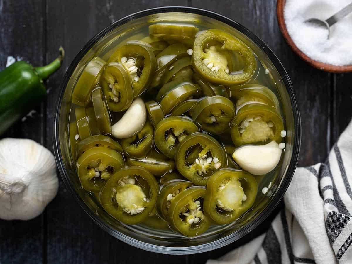 Overhead view of a bowl full of pickled jalapeños.