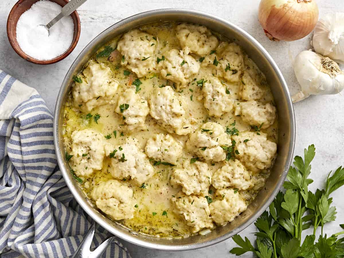 Overhead view of chicken and dumplings in a skillet.