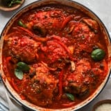 overhead view of chicken cacciatore in a white pan.